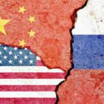 Tensions Soar: China, Russia Challenging U.S. Militarily Flags of China, the USA, and Russia depicted on a cracked surface