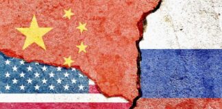 Flags of China, the USA, and Russia depicted on a cracked surface