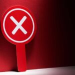 86% of Americans Say NO to Trump Red sign with a white 'X' symbol against a dark background