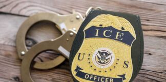ICE officer badge next to handcuffs