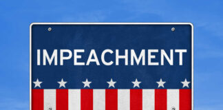 Sign displaying the word 'IMPEACHMENT' with a patriotic design