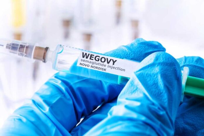Close-up of a syringe labeled Wegovy with a gloved hand holding it