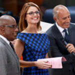 Command Post MOVED — Guthrie Investigation Update Three television hosts smiling and engaging with the audience during a live broadcast