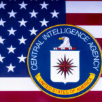 CIA emblem over United States flag background.