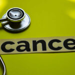 Game-Changing Cancer Weapon Revealed A stethoscope next to the word 'cancer' on a yellow background