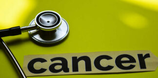 A stethoscope next to the word 'cancer' on a yellow background