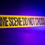Yellow crime scene tape with the words 'CRIME SCENE DO NOT CROSS'