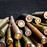 Close-up of assorted rifle bullets on a dark background.