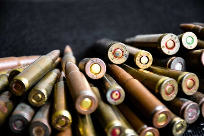 shutterstock_2146986993.jpg Close-up of assorted rifle bullets on a dark background.