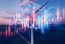 Wind turbine with digital data overlay against a sunset sky