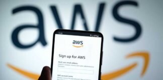 Mobile phone displaying AWS signup page with logo in background