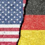 Torn representation of the American and German flags