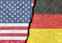 Torn representation of the American and German flags