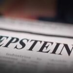 FBI Files Force Epstein Ranch Raid Close-up of a newspaper headline reading 'EPSTEIN'