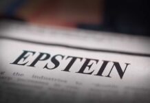 Close-up of a newspaper headline reading 'EPSTEIN'