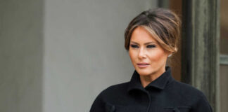 Melania Trump in black coat.