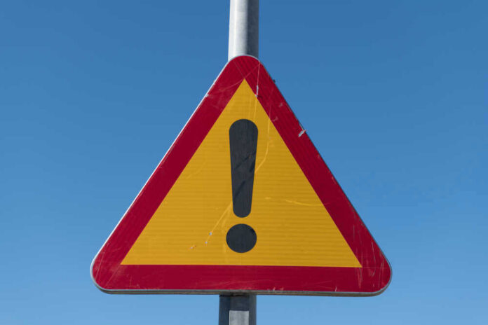 shutterstock_1306935058.jpg Triangular warning sign with exclamation mark.