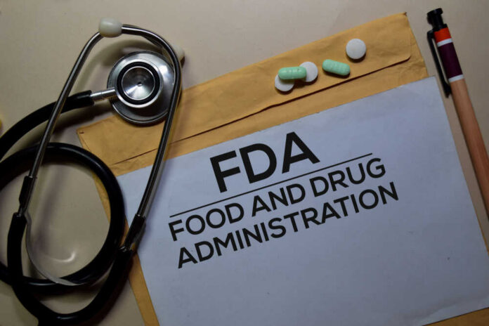 Stethoscope and medication on a folder labeled FDA