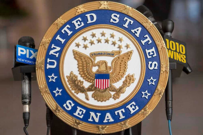 shutterstock_2130082274.jpg United States Senate seal with microphones in front.