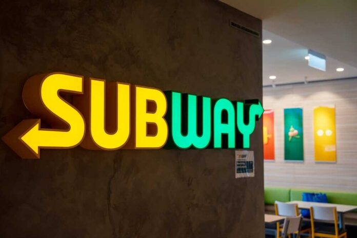 Illuminated Subway restaurant sign with green and yellow colors