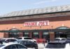 Exterior view of a Trader Joe's grocery store with parked cars