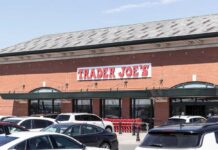 Exterior view of a Trader Joe's grocery store with parked cars