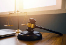 Gavel and scales of justice on desk.