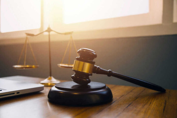 Gavel and scales of justice on desk.