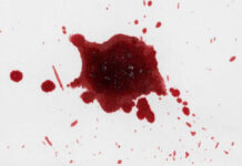 Red liquid splatter on a white background.
