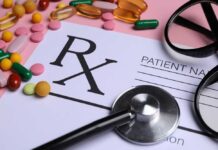 Prescription pad with various colorful pills and a stethoscope