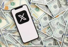 Smartphone displaying the X logo on a background of hundred dollar bills