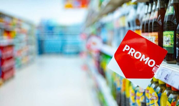 shutterstock_2555921175.jpg Promotional sign in a grocery store beverage aisle
