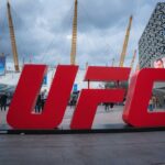 Large red UFC sign in front of a busy outdoor venue