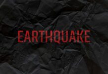 Crumpled black paper with the word 'EARTHQUAKE' in bold red letters