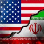 A cracked wall displaying the flags of the USA and Iran, symbolizing conflict