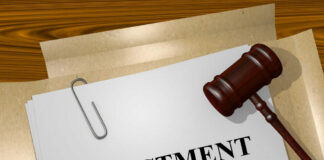 Gavel on a white paper with the word indictment on it.