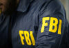 FBI agent in navy blue jacket.