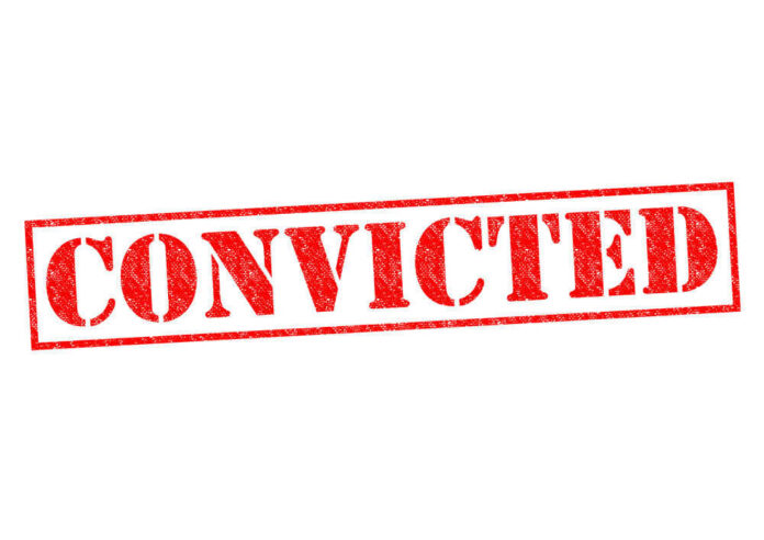 Red stamped text convicted on white background