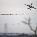 Power Bank SCARE! Emergency Landing Bombshell Airplane taking off view through barbed wire fence