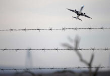 Power Bank SCARE! Emergency Landing Bombshell Airplane taking off view through barbed wire fence