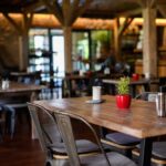 Deadly Wind-Driven Tragedy Interior of a cozy restaurant with wooden tables and decorative plants