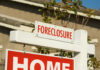 Foreclosure sign indicating a home for sale