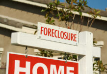 Foreclosure sign indicating a home for sale