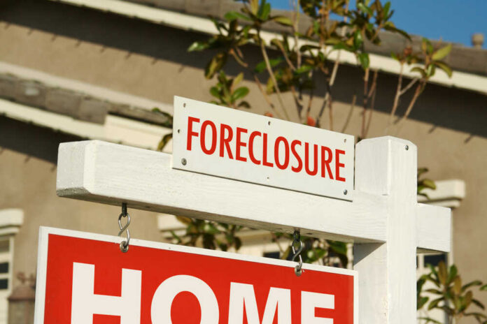 Foreclosure sign indicating a home for sale