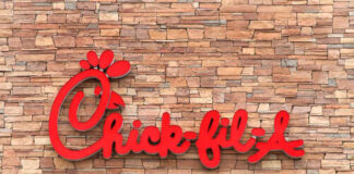 Chick-fil-A restaurant sign on a stone wall