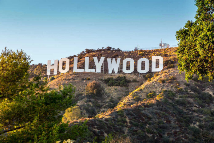 shutterstock_114467512-1 Hollywood Sign on a green hillside, sunny day.