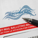Supreme Court Shocks Election Day Vote-by-mail envelope with pen on top.