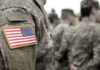 Appeals Court Attacks Pentagon Ban U.S. soldiers in camouflage uniforms with American flag patch.