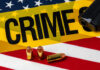 Bullets Shred American Family Festival A gun and bullets on an American flag with a crime scene marker