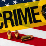 Bullets Shred American Family Festival A gun and bullets on an American flag with a crime scene marker